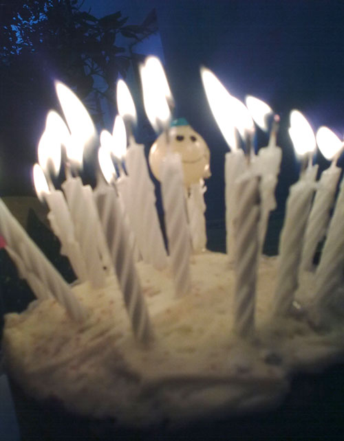 The Origin of Birthday Candles - photo of lit birthday candles on cake 
